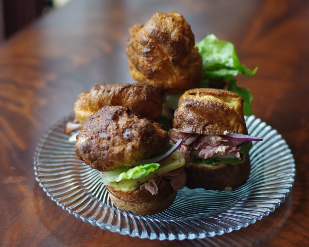 How to make popovers: popovers on a plate stuffed with roast beef, red onion and lettuce