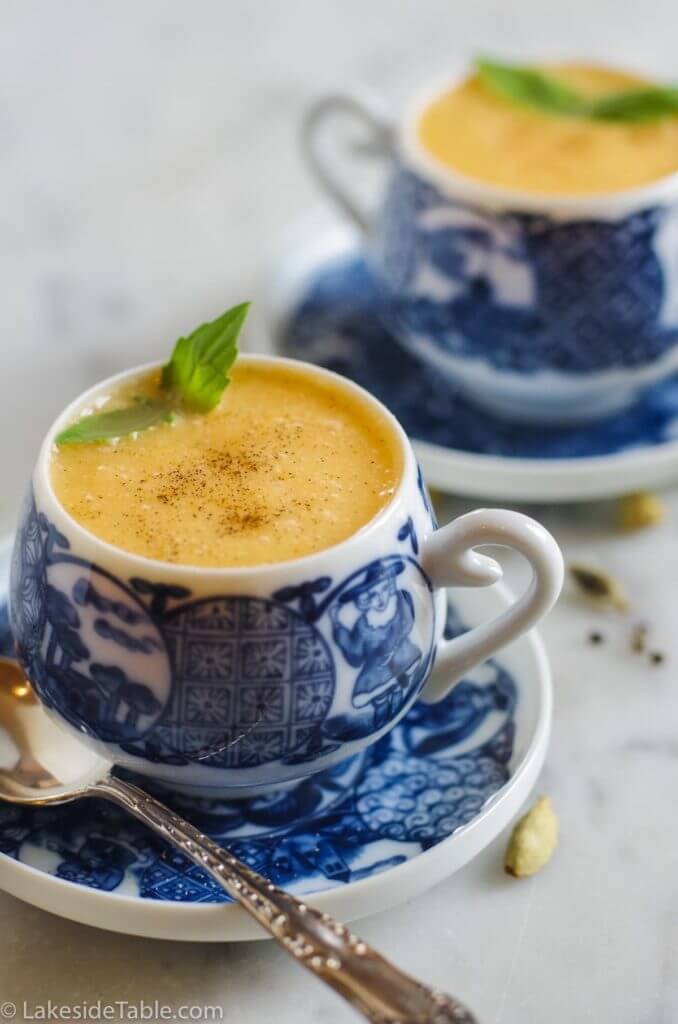 cantaloupe soup in little blue and white cups on matching saucers