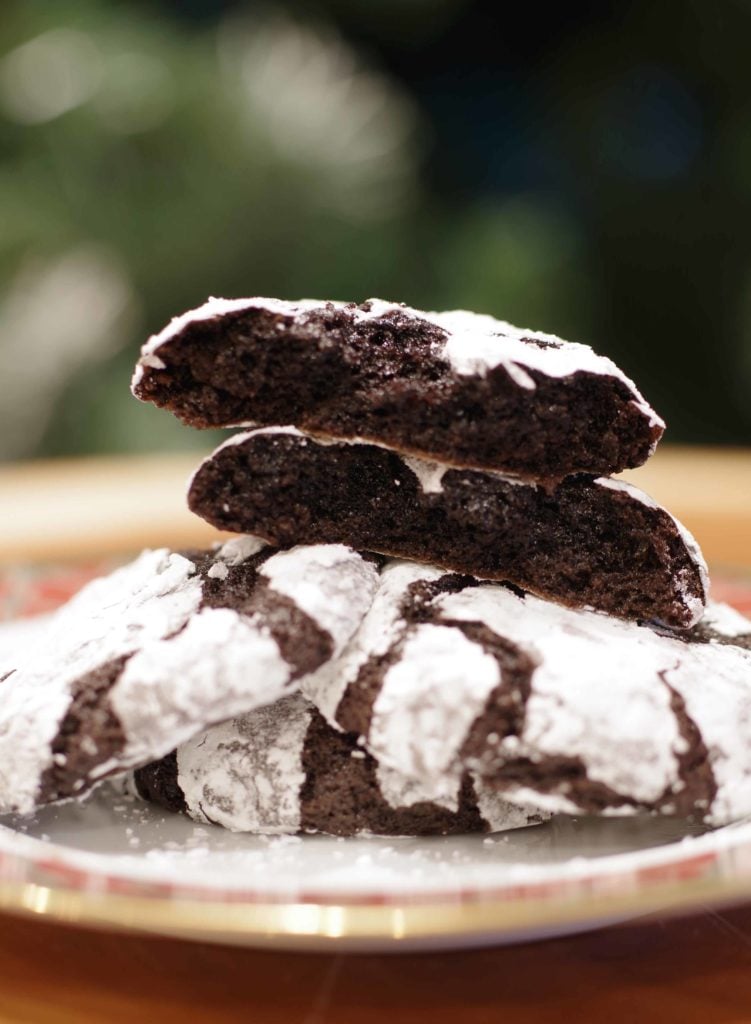 Pile of chocolate snowflake cookies with the top one torn open