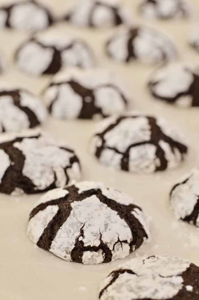 fresh out of the oven chocolate snowflake cookies on cookie sheet