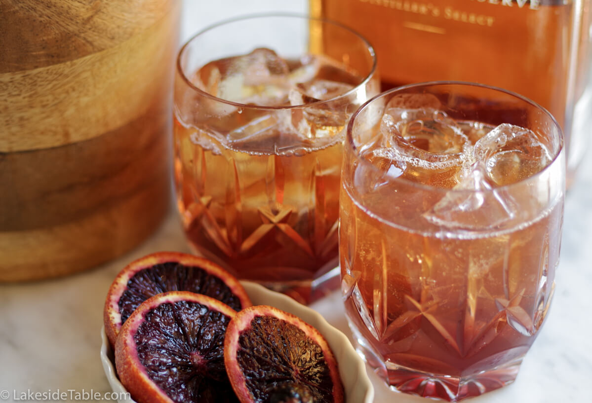 Old Fashioned Cocktail Recipe - Put a little twist on a classic by using blood oranges and black maraschino cherries. So refreshing! | www.lakesidetable.com