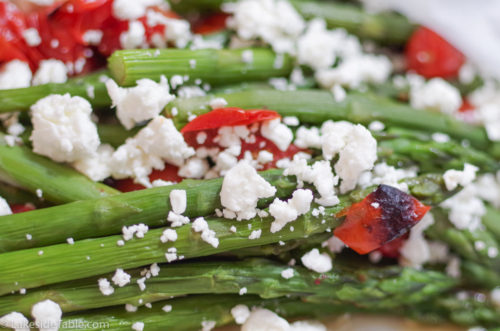 Braised green asparagus with white feta cheese and charred cherry tomatoes