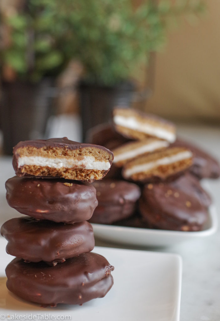homemade mini moon pies stack 4 high with the top one cut in 1/2 so you can see the marshmallow and graham cookie.