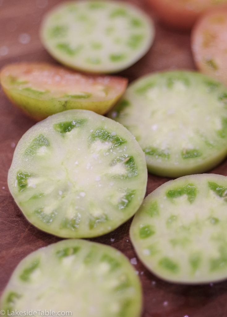 Sliced raw unripened green tomatoes