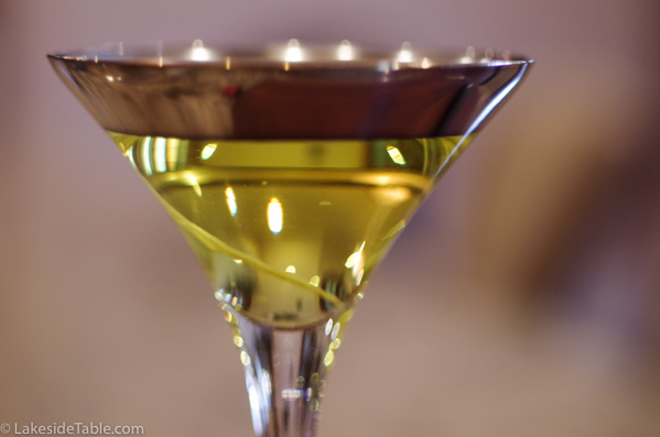 martini glass with silver band and light yellow turmeric infused vodka