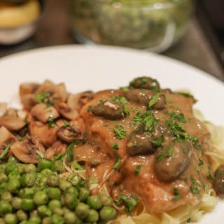 plated turkey piccata with peas and mushrooms