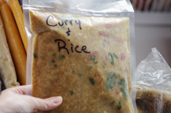 vacuum sealed bag of red curry soup coming out of freezer