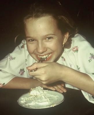 young girl (me) eating cream pie.
