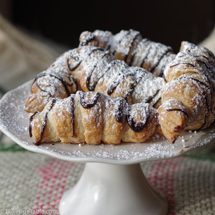 Joe Sippers Cafe chocolate croissants with powdered sugar on a white cake stand