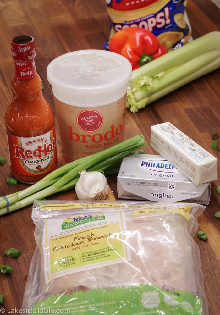 Ingredients for healthy keto buffalo chicken dip: chicken breast, franks hot sauce, chicken broth, garlic, butter, cream cheese and green onions