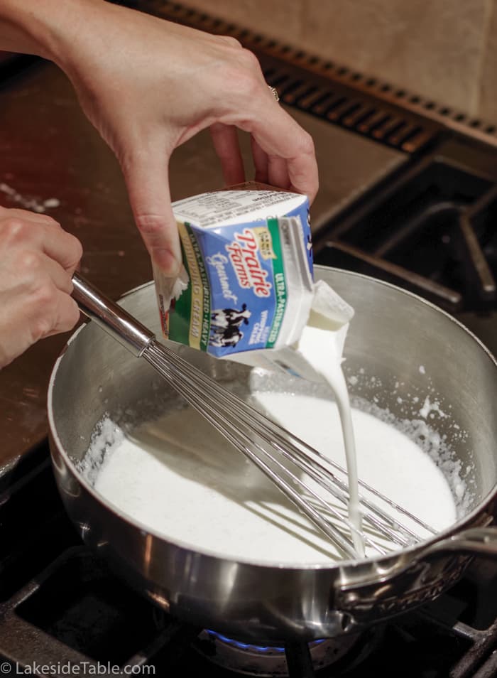 pouring cream into milk mixture