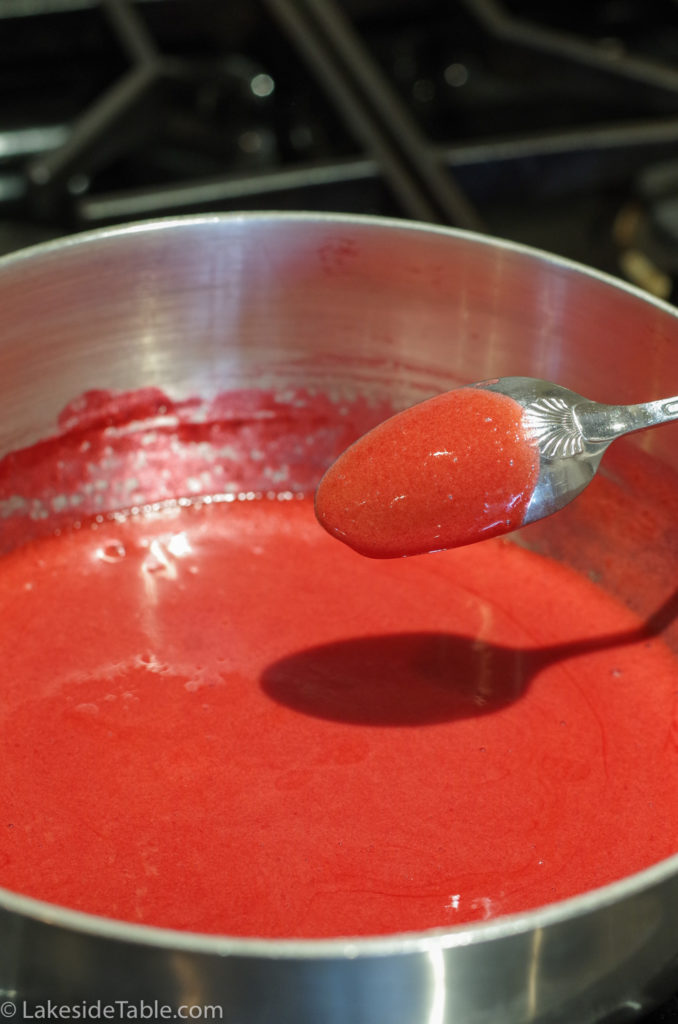 raspberry sauce coating the back of a spoon.