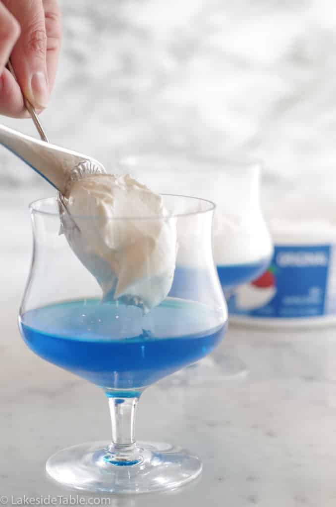 Adding whip cream layer on top of blue jello layer