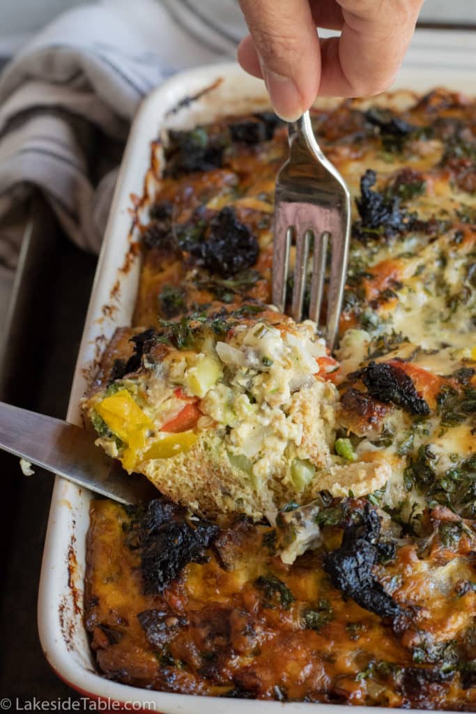 a slice of breakfast casserole coming out of the pan