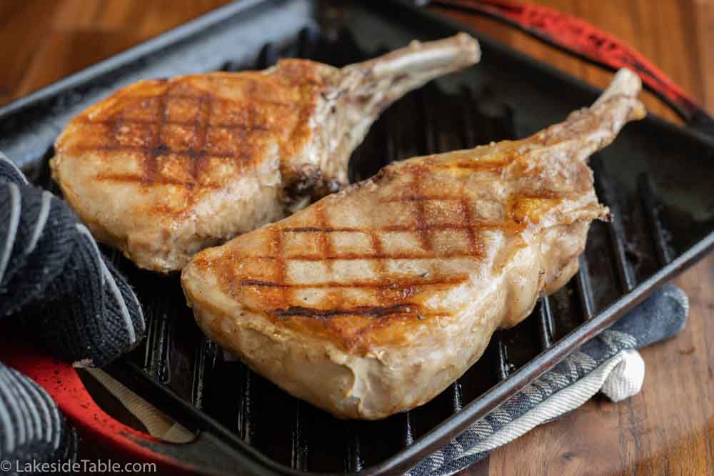 sous vide pork chops being finished in a grill pan