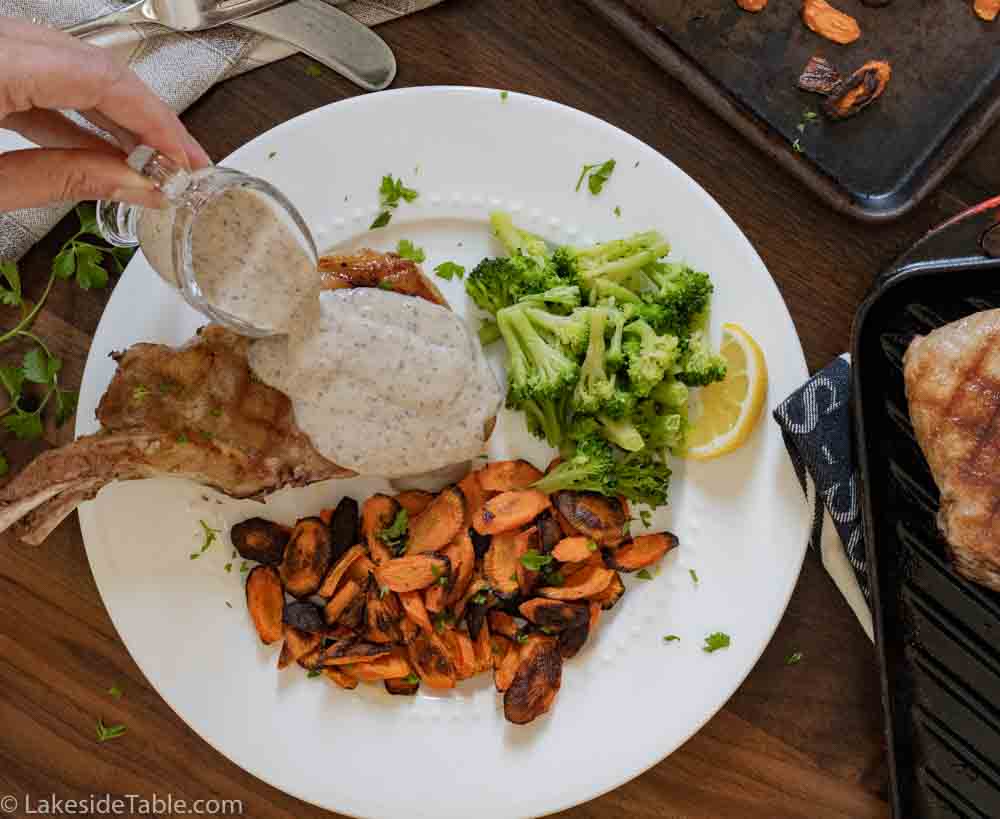 plated pork chops with broccoli and roasted carrots