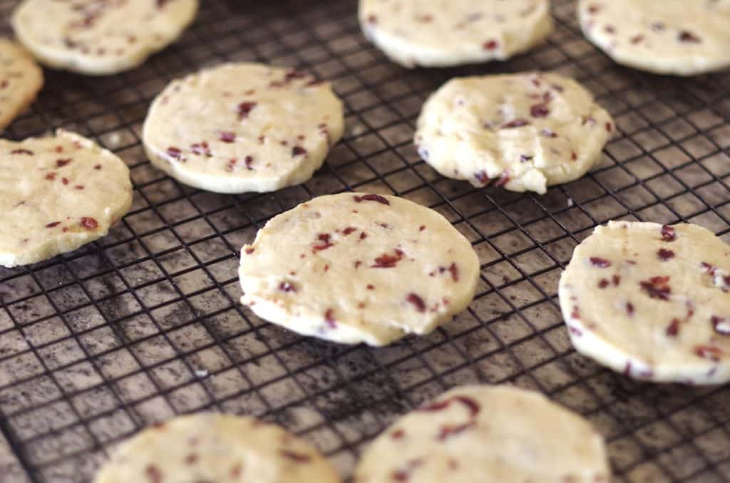 cranberry orange shortbread cookies cooling on a cooling rack