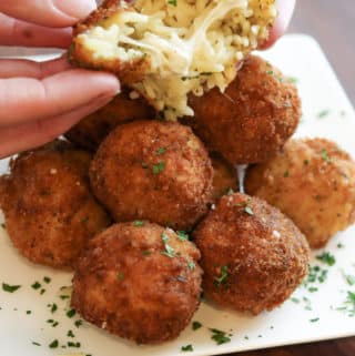 Fried mac and cheese balls opening to show inside