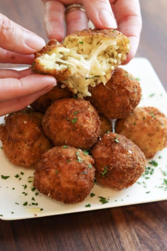 Fried mac and cheese balls opening to show inside