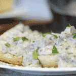 white sausage gravy with cream over biscuits