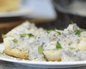 white sausage gravy with cream over biscuits