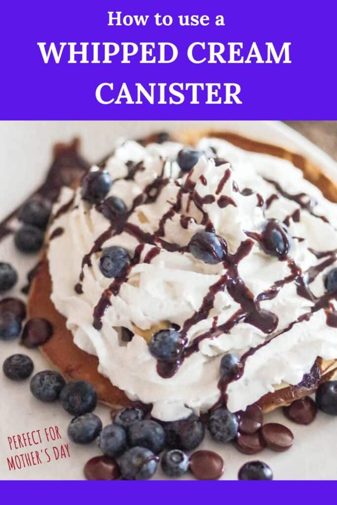 PIN for pinterest with words: how to use a whipped cream canister with a picture of a pancake covered in whipped cream with fresh blueberries and chocolate sauce