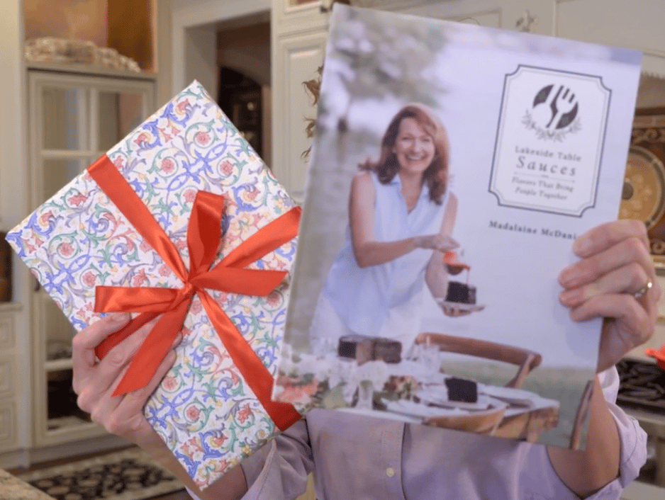 Showing gift wrapped cookbook with red bow
