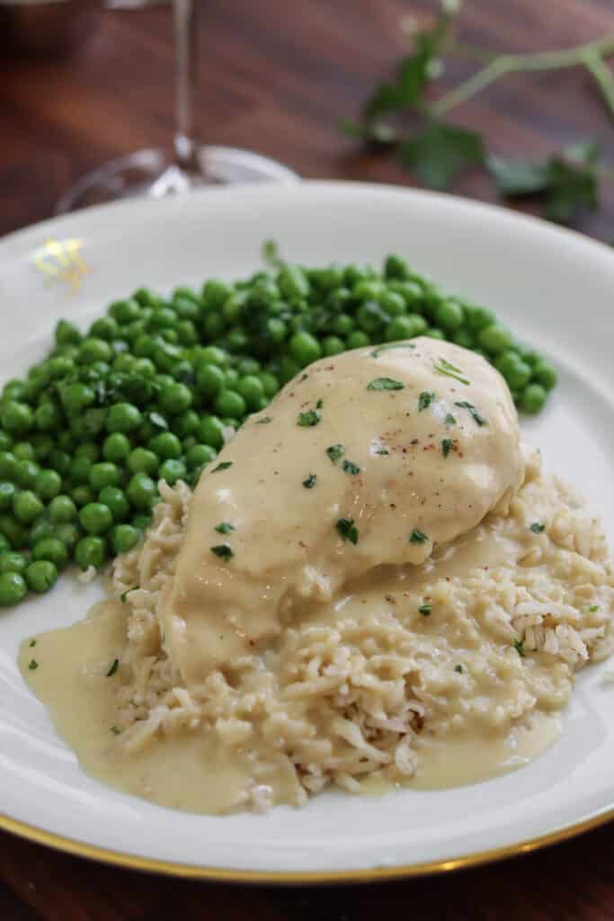 chicken with veloute sauce over rice with peas