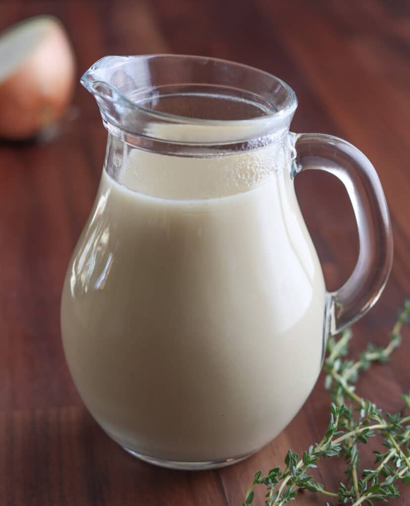 veloute sauce in a glass pitcher