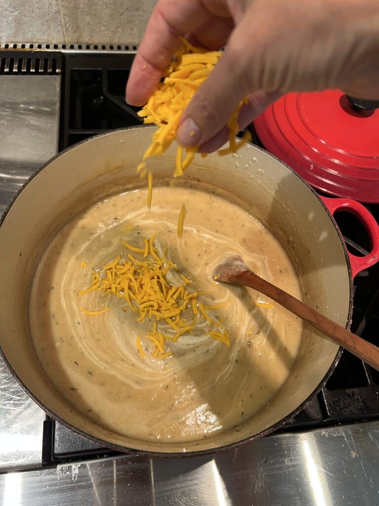 stirring cheese into beer cheese soup