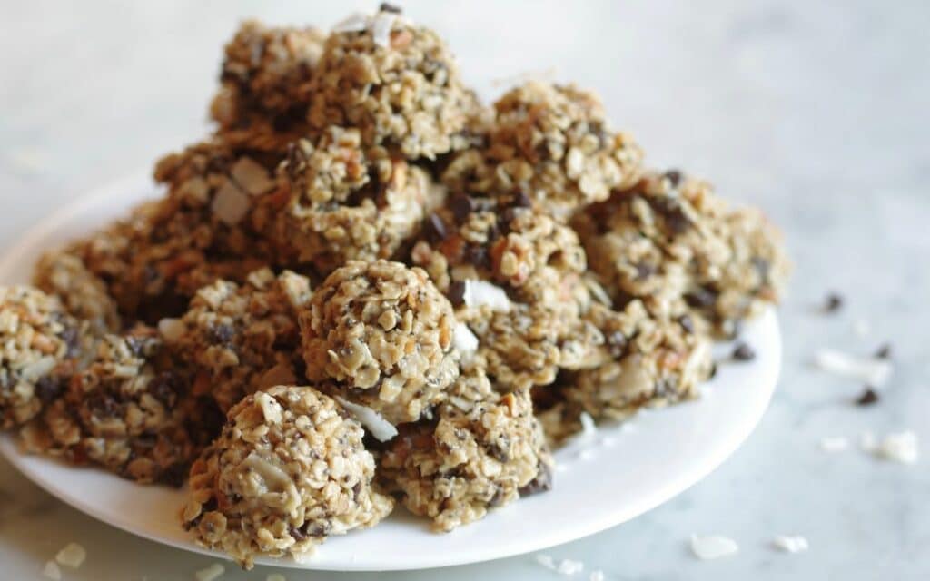 White plate piled high with bite sized energy balls 