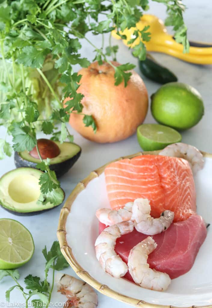 ceviche ingredients: raw fish salmon, tuna, shrimp, limes, grapefruit, avocado, jalapeno, cilantro