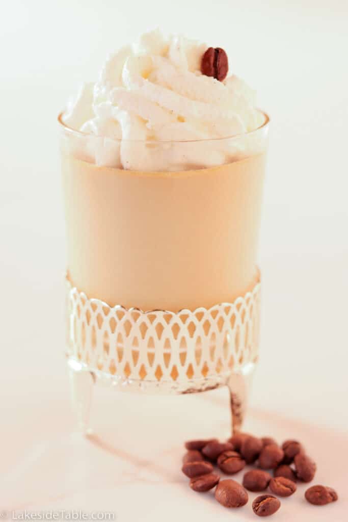espresso panna cotta with whipped cream and coffee beans