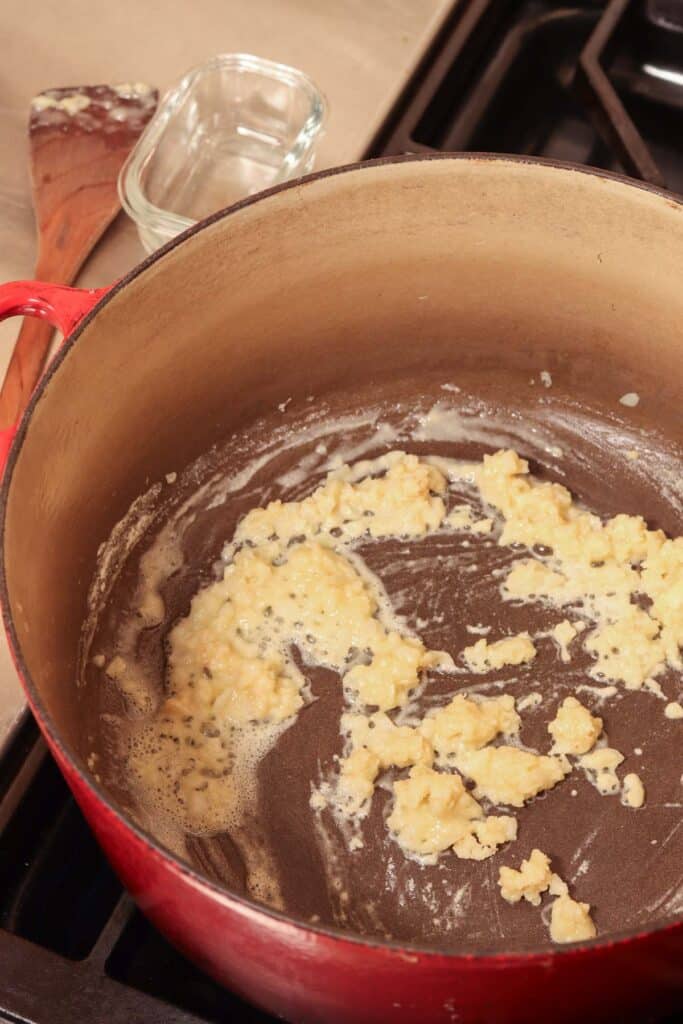 cooking the flour with the butter and onions in a soup pot on the stove