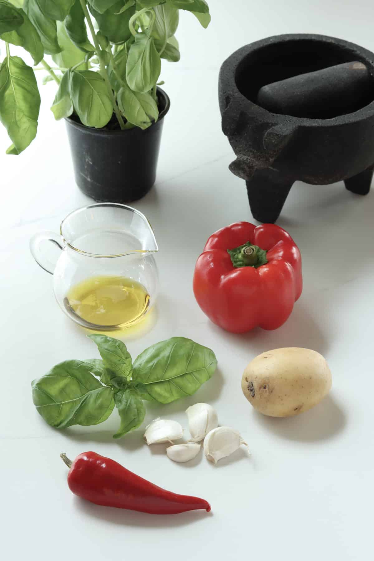 simple ingredients for rouille: basil, chili, garlic, potato, red bell pepper, olive oil