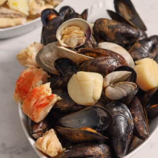 succulent mussels and clams in a white serving dish