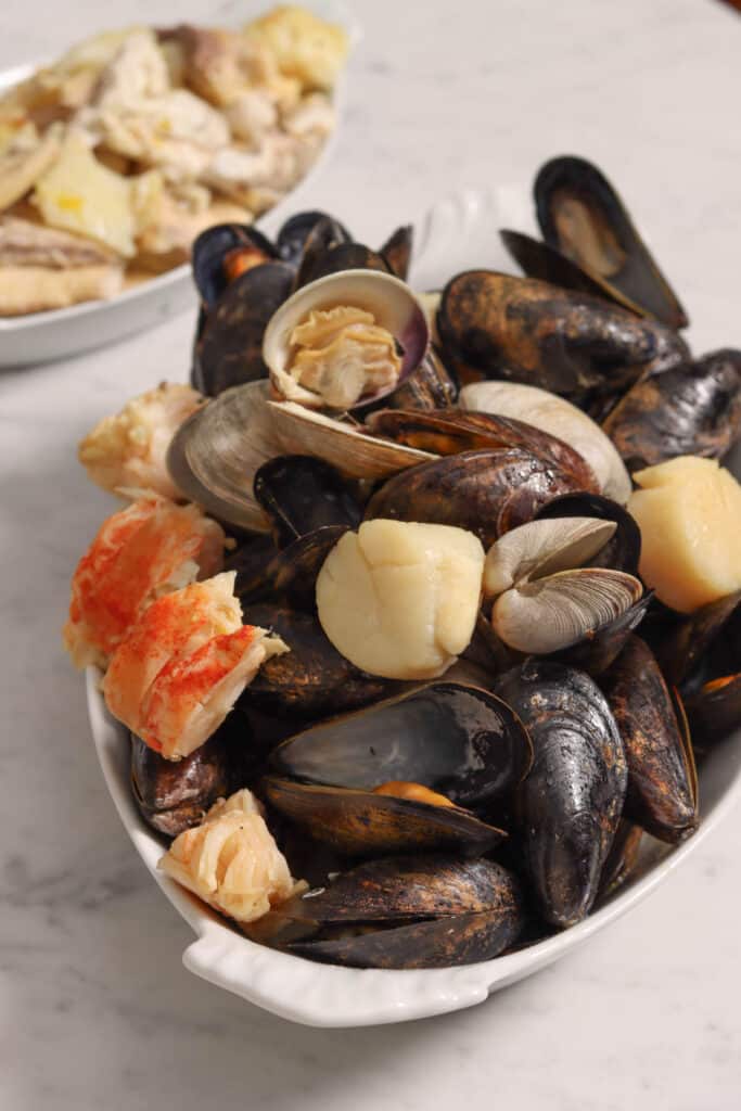 succulent mussels and clams in a white serving dish